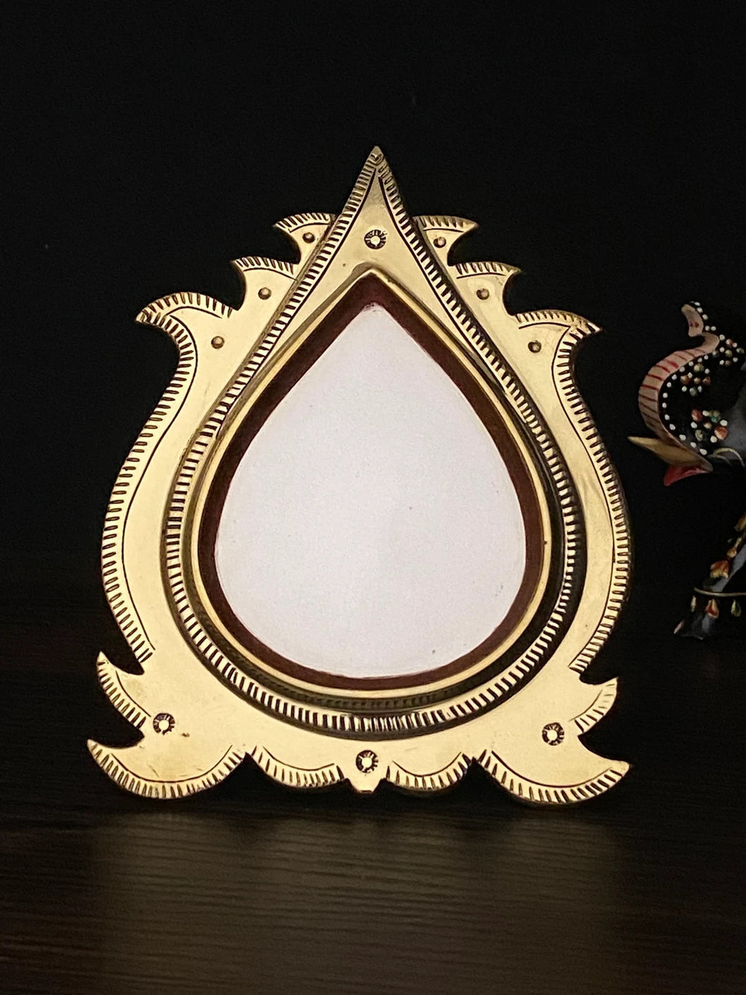 aranmula kannadi with a drop shape mirror with backstand.