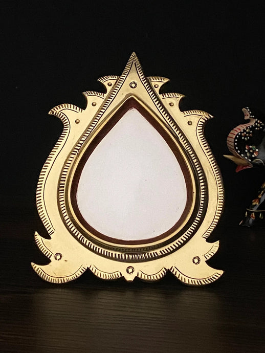 aranmula kannadi with a drop shape mirror with backstand. 